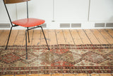 Malayer runner section: decorative distressed geometric pattern with animal motifs, salmon, olive, brown.