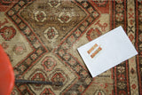 Distressed antique Malayer rug pattern with abstract animals, walnut brown, ivory, and salmon.