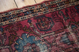 Distressed pile texture of a vintage Lilihan rug in fuchsia and azure blue.