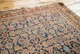 Rhythmic distressed herati motif in faded indigo and terra cotta on an antique Malayer.