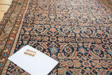 Antique Malayer rug with distressed herati pattern, indigo field, and barber pole border.