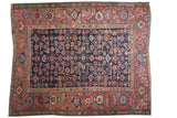 Antique Northwest Persian rug with indigo herati field, stylized red samovar border, late 19th century.