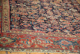 Angled detail of antique Northwest Persian rug with vibrant jewel tone herati motifs and stylized samovar border.