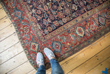 Antique Northwest Persian rug's vibrant red border with stylized samovar and indigo herati field.