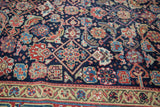 Detail of antique Northwest Persian rug: rich indigo field with herati motifs, and stylized samovar-turtle border.