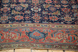 Antique Northwest Persian rug's ruby red border with stylized samovar-turtle motif, light end wear.