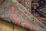 Antique Northwest Persian rug's hand-knotted foundation revealed, showing a red border and secured edge.