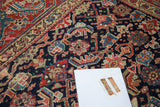 Vibrant jewel-tone herati motif and stylized samovar border on antique Persian rug.