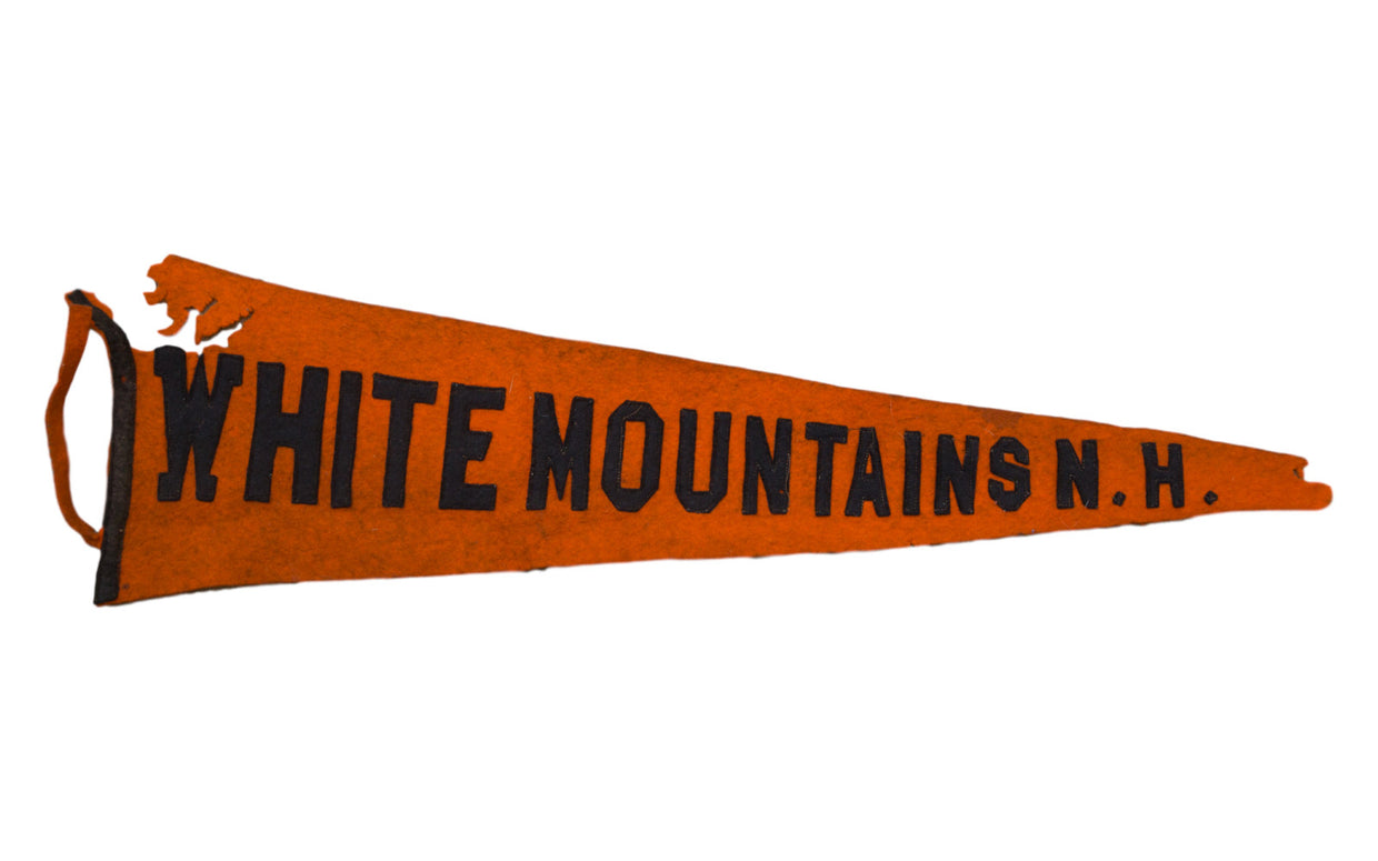 Antique orange felt White Mountains N.H. banner, handmade with black letters, showing historical wear, 6.25 x 22 inches.