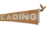 Hand-sewn cream 'READING' letters on an antique rust wool felt pennant.