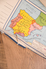 Vintage Denoyer Geppert map showing Portugal, Castile, Aragon, and edge tear.