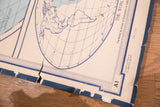 Vintage Denoyer Geppert World Map, detail of a large rip and creases on its blue border.