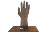 Vintage black glove mold displaying an industrial style with authentic surface wear.