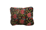 Antique Rose Rug Fragment Pillow with dark ground, pink rose blooms, and green leaves.