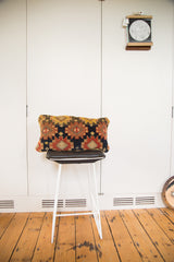 Antique Rug Fragment Pillow featuring unique geometric patterns with golden yellow abrash and deep red tones.