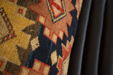 Antique rug fragment pillow, geometric pattern with golden yellow, indigo, and rust abrash.