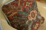 Antique Mahal Persian rug pillow's terracotta and aqua pattern meeting light blue backing.