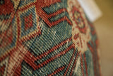 Close-up of antique Mahal rug pillow, hand-knotted terracotta and aqua blue geometric design.