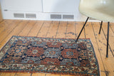 Copper red and navy blue rams horn motifs on this vintage Lilihan rug.