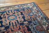 Geometric rams horn and herati elements visible on a vintage Lilihan rug corner.