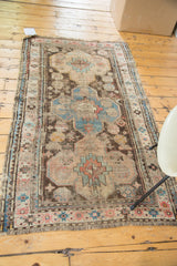 Antique Caucasian rug corner, worn fringe, pink and blue geometric border.