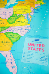 Pink Florida, map legend, and light blue ocean on vintage USA pull down map.