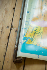Washington state and British Columbia on vintage pull-down map with aged dowel.