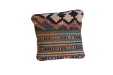 Vintage Kilim pillow showcasing reclaimed fragment with faded geometric and striped designs.