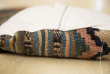 Pillow side detail: Faded blue, brown, beige striped kilim and ivory linen backing.