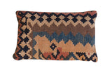Antique circa 1915 Kilim lumbar pillow with faded geometric patterns in blue, beige, brown, and rust, 12x20.