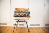 Antique Kilim lumbar pillow featuring geometric patterns and beautifully faded hues.