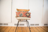 Antique circa 1915 Kilim lumbar pillow, faded coral with geometric blue diamonds.
