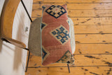 Antique Kilim pillow with faded terracotta, deep blue geometric design, and light blue piping.