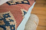 Aged flat weave Kilim fragment, with geometric pattern, bordering light blue linen pillow back.