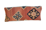 Antique Kilim lumbar pillow with faded geometric diamonds in terracotta, navy, and tan, 10x24.