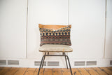 Antique Kilim Throw Pillow with geometric bands in faded blue, rust, and beige.