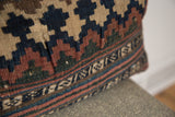Woven texture and faded blue, beige, and rust geometric pattern of an antique Kilim pillow.