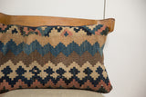 Antique Kilim pillow's handwoven geometric pattern with faded blue, beige, and brown tones.