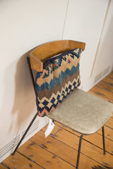 Antique Kilim lumbar pillow with time-softened geometric pattern and navy brushed cotton backing.