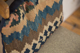 Faded blue, tan, and brown geometric pattern on antique Kilim lumbar pillow.