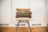 Purple Bibikabad rug fragment lumbar pillow with ornate orange and green floral motifs.