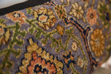 Intricate floral motifs and hand-knotted texture of a purple Bibikabad rug fragment.