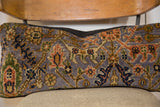 Hand-knotted purple Bibikabad rug fragment detail, showcasing traditional orange, green, and blue motifs.