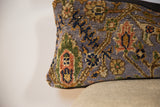Purple Bibikabad rug fragment pillow, textured pile with blue, green, and orange floral motifs.