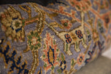 Hand-knotted texture and curvilinear motifs of the purple Persian Bibikabad rug fragment.