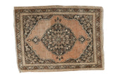 Antique Tabriz rug with abrashed copper field, central medallion, and meandering leaf border.