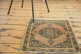 Antique Tabriz rug corner with scalloped spandrel, dark medallion, copper field, and leaf border.