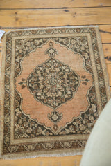 Scalloped corner of antique Tabriz rug, abrashed copper field, charcoal floral spandrel, light meandering border.