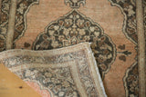 Hand-knotted foundation and fringe detail of antique Tabriz rug's folded corner.