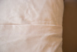 Pillow backing: organic cotton canvas with envelope closure and zig-zag stitching.